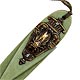 This bookmark was made in the US by an unknown manufacturer. It is made of green celluloid and brass and still has the original tassel. On the top blade, is a cicada standing on an urn. The date is probably 1910 - 1930. The bookmark has no manufacturers markings.