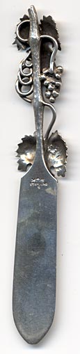 This is an American made bookmark. The manufacturer is Gorham. It is marked with the manufacturers hallmark, Sterling and the catalog number 4. It large and heavy for a bookmark. It has the picture of grapes on a vine. It's nicely detailed. It is from the Autumn 1888 Gorham Catalog. It is one of 33 different bookmarks offered that year. 