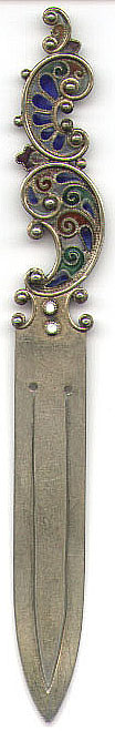 This bookmark is from Oslo, Norway by Norsk Filigransfabrikk. It is marked with a makers hallmark and stamped 925. It is finished in a gold wash and has a translucent stained glass like design at the top called plique-a-jour. The dealer said it was made circa 1890 - 1900.