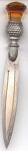 This bookmark made in England and has the makers hallmark of C&N It is marked Silver after the hallmark (not Sterling). The top has an amber color citrine stone set in a silver thistle.
