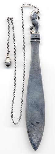 This bookmark was made in Denmark by Georg Jensen sometime after 1945. It is a fish hooked to a chain. The other end of the chainis a ball. This can also be seen in the new 1997 book on Georg Jensen silver.
