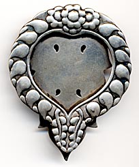 This bookmark was made in Denmark by Georg Jensen. It is marked GI, 61, and Sterling Denmark. This is an old mark used before 1920. The bookmark is in the shape of a wreath with the center in the shape of a heart.