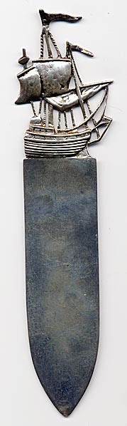 This bookmark was made in London, England in 1906. It is marked J.D. with the English marks for the place and date. It is also marked J. Dudley Southsea. It is a large and solid mark with the top depicting a tall sailing ship.