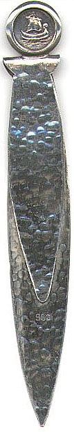 This bookmark looks like it has been hand hammered to make an interesting texture. It has a picture of an old boat within a round frame at the top. It is marked 900 on the front. It is probably European (Germany or Norway) and from the 1920's.