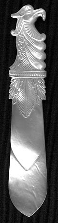 This bookmark was made in France circa 1840 - 1850. It is hand carved and made of solid mother of pearl. The top is a bird head with a large beak and feathers underneath it.