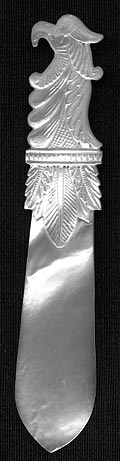 This bookmark was made in France circa 1840 - 1850. It is hand carved and made of solid mother of pearl. The top is a bird head with a large beak and feathers underneath it.