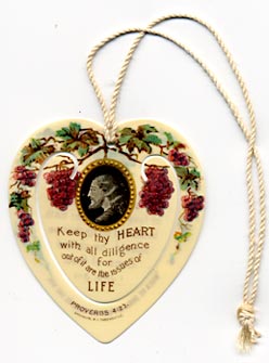  This bookmark was made in the US for the Brooklyn, NY Tabernacle. This is a very RARE bookmark that was handed out by C. T. Russell at the 1913 Conventions of the International Bible Students. It is a religious celluloid bookmark with a picture of a man's head in an oval frame hanging from a grape vine. Underneath it says "Keep thy HEART with all dilligence for out of it are the issues of LIFE." This quote is from Proverbs 4:23. The back is a quote from I JNO 3:1 which says "Behold, what manner of love the Father hath bestowed on us that we should be called Sons of God." Also is says "When He shall appear we shall be like Him."  