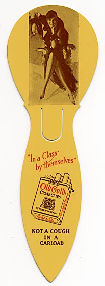  This bookmark was made in the US between 1910 - 1920. It is a celluloid advertising bookmark for "Old Gold" cigarettes. It has a photo of a woman sitting in a chair with her legs crossed and a cigarette in her hand. The advertisement says "In a Class by themselves. Not a cough in a carload." 