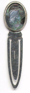 This bookmark English made. It has a manufacturers mark of AN and a date mark of V indicating 1995. It is also marked 925. The top is a picture of a young girl and the material is mother of pearl.
