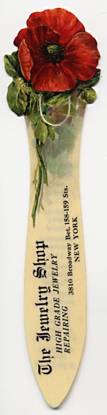  This bookmark was made in the US for The Jewelry Shop in New York. It is a celluloid advertising bookmark with a red flower on top. The back is a list of every month and the birth stone and a word for the month. The date is 1900 - 1910.