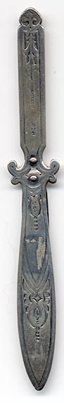 This bookmark was made in the US by Gorham. It is marked with the manufacturers hallmark and Sterling. It is in the shape of a knife with hand chasing all over. It was also used as a letter opener. The date is 1875 - 1890.