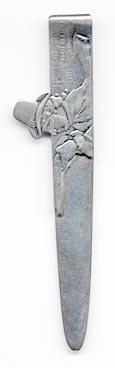 his bookmark was made in the US by Gorham. It is marked with Gorham, the makers hallmark, and Sterling. It is a figural of a Highwayman with a mask and a gun. The front says, "He robs us of nothing but care.". The back says, "Souvenir of the 150th Performance. The Highwayman. March 21st, 1898. Broadway Theatre Opera Company. Andrew McCormick, Manager."