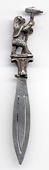 This bookmark is made in Birmingham, England. It is marked with the the date mark of 1927 and the hallmarks for Birmingham. It has a figural bear holding a large pick axe.