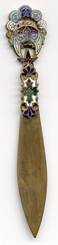 This bookmark was made in France by an unknown manufacturer. It is a colorful enamel and brass cloisonne piece know as Battersea. The date is 1900 - 1910.