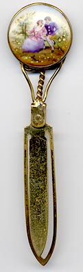  This bookmark was made in Europe, possibly France. The top is a hand painted porcelain medallion with a couple in 18th century garb. It is a brass bookmark with a dore finish. The date is 1870 - 1900.  