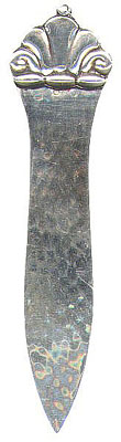 This bookmark is Danish marked with the Swedish import marks. It is marked lmp. H.Gr. 830 S on the back. It has a scallop shell on the top and the blade is hand hammered. Date is 1917 - 1938.