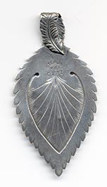  This bookmark was made in the US by D.S. Spaulding of Mansfield, Massachusetts. It is marked sterling with the makers hallmark on the back. It is a beautiful piece in the shape of a leaf. The top has a feather folded over. The top blade has a flower design. The date is 1900 - 1910.   
