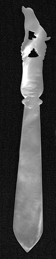  This bookmark is a French Palais Royal mother-of-pearl  hand carved figural poodle sitting up on a pair of leaves. The date is 1880 - 1900.   