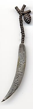  This bookmark was made in the US by William C. Finck Co. It is marked sterling and WC Finck. The top has a figural pine branch with a pine cone hanging down. The date is 1896 - 1904. 