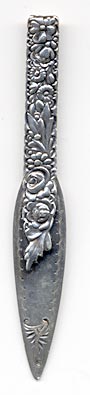  This bookmark was made in the US by Gorham. It is marked with the manufacturers hallmark and 14. This is one of the 33 bookmarks from the Autumn 1888 Gorham catalog. The handle and top blade have a array of flowers and leaves. The date is 1888.  