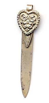 This bookmark was made in the US by an unknown maker. It is marked sterling on the back. The top is an ornate heart shape. The date is early 20th century.