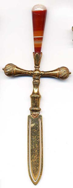 This bookmark was made in England or Scotland. It is in the shape of a sword where the top is a large piece of banded agate. The date is 1900 - 1910.