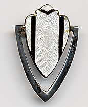 This bookmark was made in the US by an unknown manufacturer. It is marked with a hallmark of a triangle enclosing the letter H and sterling. The top is a white and black enamel shield. The date is 1900 - 1910.