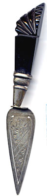 This bookmark is made in England. It is shaped like a trowel and has a Jet handle. The blade has a flowery design. There are no hallmarks.