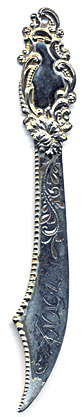 This bookmark was made in the US by an unknown manufacturer. It is marked sterling on the small blade on the back. It is in the shape of a sword with an art nouveau design on top. The blade is inscribed "Anna."