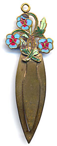 This bookmark is made of brass with enamel flowers on top. The manufacturer is unknown.
