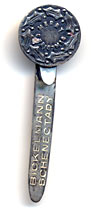 This bookmark was made in the US by an unknown manufacturer. The top is a is a holly plant and says Merry Christmas. The blade says Bickelmann Schenectady.