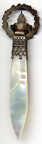 This bookmark was made in France as a souvenir of the Musee de L'Armee. It is brass, abalone and mother-of-pearl.  The top has a bust of Napoleon and a wreath surrounding a building labeled Paris. The building is the Musee de L'Armee, located at the Invalides in Paris, France. Originally built as a hotel for disabled soldiers (Invalides) by Louis XIV, it now houses the Tomb of Napoleon 1st and the museum of the Army of France.
