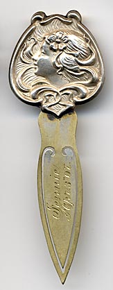 This bookmark was made in the US by an unknown manufacturer. It is marked Sterling Front meaning that only the top part is silver. It depicts an art nouveau lady blowing wind with a flower in her hair. The blade is inscribed "Jennie Apr 3 '07"