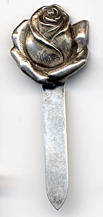 This bookmark was made in the US by Unger Bros. It is hallmarked with the manufacturers mark of an intertwined U and B. The top is a rose flower just starting to bloom. To see the catalog page select "Catalog Unger Bros 1904" from the Books, Catalogs and Patents dropdown menu.