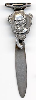 This bookmark was made in the US by Watson Company. It is marked with two "$" signs with sterling inbetween. The top is the head of a bearded man.