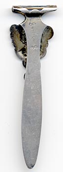 This bookmark was made in the US by Watson Company. It is marked with two "$" signs with sterling inbetween. The top is the head of a bearded man.