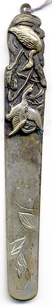 This bookmark was made in Japan by an unknown manufacturer at the turn of the 20th century. It is silver plate over brass and has a high relief picture of birds.