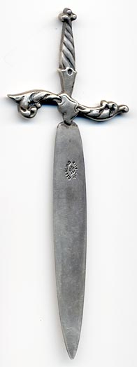 This bookmark was made in the US by Reddall & Co. It is marked with their hallmark of a crown. The bookmark is in the shape of a sword.