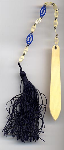 This bookmark was probably made in Europe somewhere. It is celluloid with a celluloid link chain and a large blue tassel. The date is 1920 - 1930.