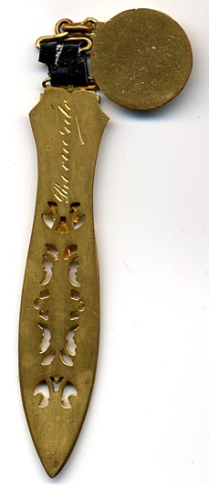 This bookmark was made in France. It is gold dor&egrave; and has an enamel upper blade with a cutout longer blade. Attached at the top by a small piece of leather is a medallion with an enamel bird and the inscription "Messagere du Printemps" (Messenger of the spring).