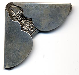 This bookmark was made in the US by Gorham. It is marked Gorham sterling 1398. It is a corner bookmark with flowers on the top. 