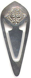 This bookmark was made in the US by Stieff Company. It is marked Stieff Sterling. It is the same shape as the other Stieff bookmark but has the image of roses on the front. These roses are very similar to the S Kirk bookmarks. Date is probably the 1980's.