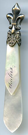 This silver plate and mother of pearl bookmark was made in France. The top has a fleur-de-lis and the the inscription on the top blade reads Amboise.