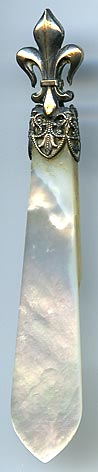 This silver plate and mother of pearl bookmark was made in France. The top has a fleur-de-lis and the the inscription on the top blade reads Amboise.