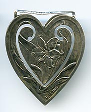 This bookmark was made in the US by Webster Co. It is marked sterling and is in the shape of a heart. The center blade has a picture of a tiger lily flower.