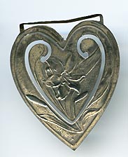 This bookmark was made in the US by Webster Co. It is marked sterling and is in the shape of a heart. The center blade has a picture of a tiger lily flower.