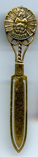This brass bookmark has a medallion with a Billiken in the center. According to Wikipedia, the Billiken was a charm doll created by an American art teacher and illustrator, Ms. Florence Pretz of Kansas City, Missouri, who is said to have seen the mysterious figure in a dream. In 1908 she patented the Billiken who was elf-like with pointed ears, a mischievous smile, and a tuft a hair on his pointed head. His arms were short and he was generally sitting with his legs stretched out in front of him.