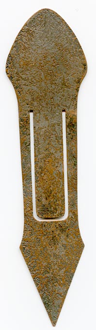 This bookmark was made in the US by the Heintz Art Metal Shop. It is unmarked. The top is sterling overlay of a flower. The bookmark is bronze with a florentine brown finish. The date is 1910 - 1920.