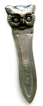 This bookmark was made in Denmark and imported into Sweden. It is marked H.J. 830s and has the Swedish import marks. The top is the face of an owl. The top blade is inscribed 26.I.1921.  