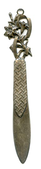 This bookmark was made in France at or around the turn of the 20th century. It is either marked with a french hallmark or it is unmarked and this is excess solder. You decide. The top is an art nouveau design of flowers.